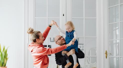 Couple with baby in clean house
