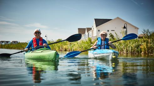 Older couple kayaking in adult living community