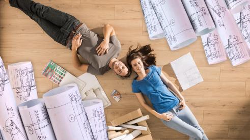 Homeowners laying on floor of home