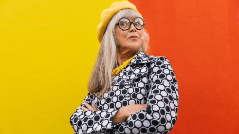 Baby Boomer woman with attitude against a red and yellow backgound