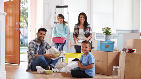 Hispanic family moving into new home and unpacking boxes