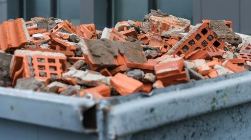 Bricks from demolition project in bin